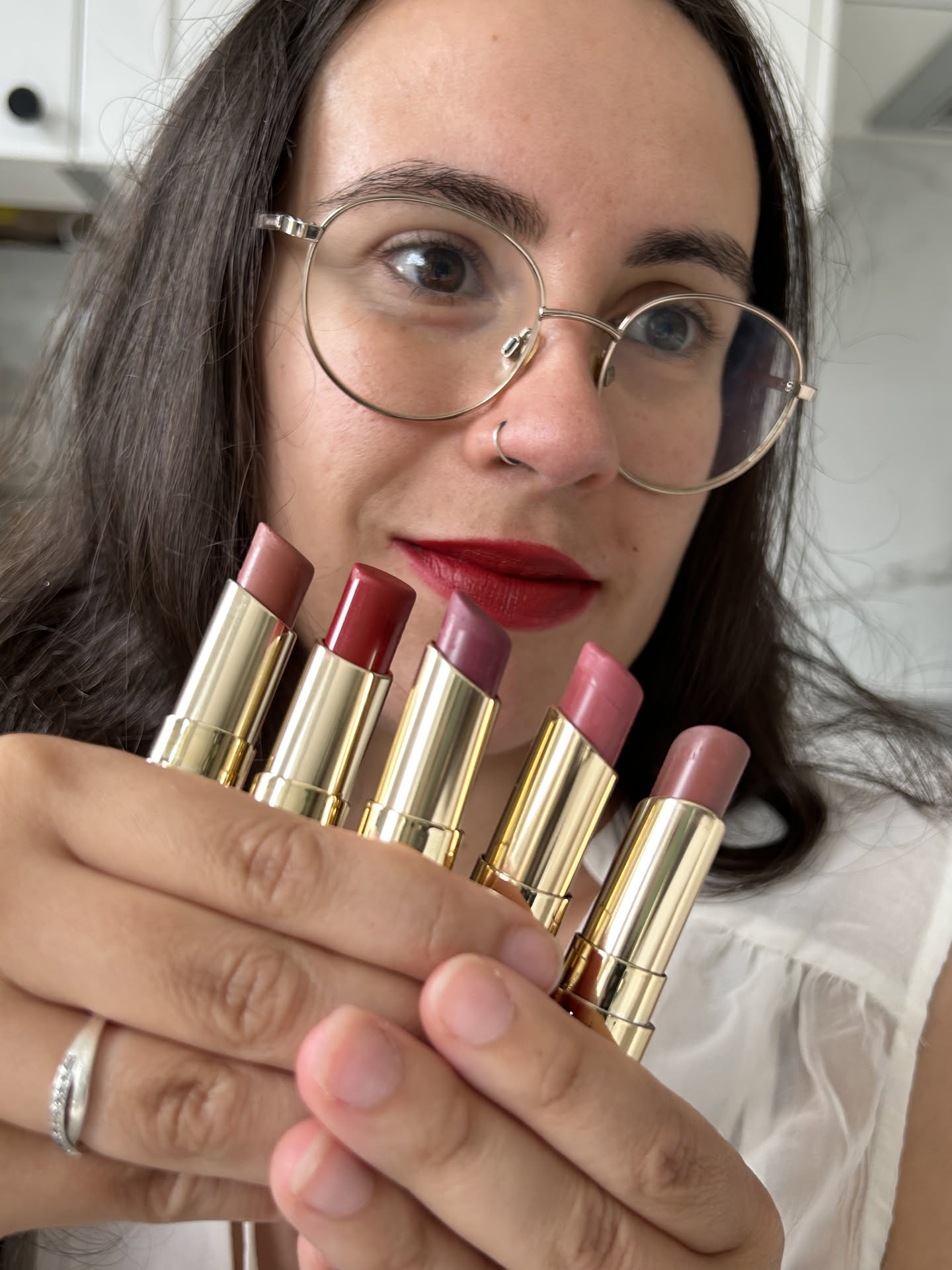 Joana holding lipstick shades for beauty content